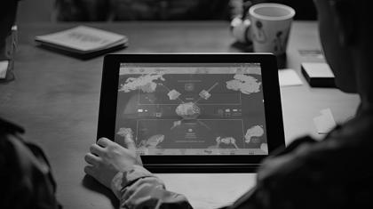a tablet computer displaying AI control interfaces, augmented reality overlays, and online coordination tools, showcasing the integration of artificial intelligence in directing military forces