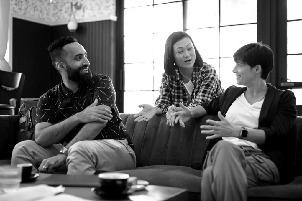 A group of people sit on a couch and talk about tech skills training.