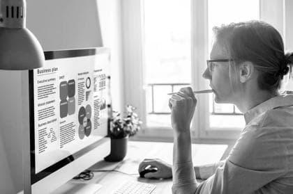 Businesswoman working on a Business Plan on computer screen to launch found raising campaign and find investors to invest in startup company