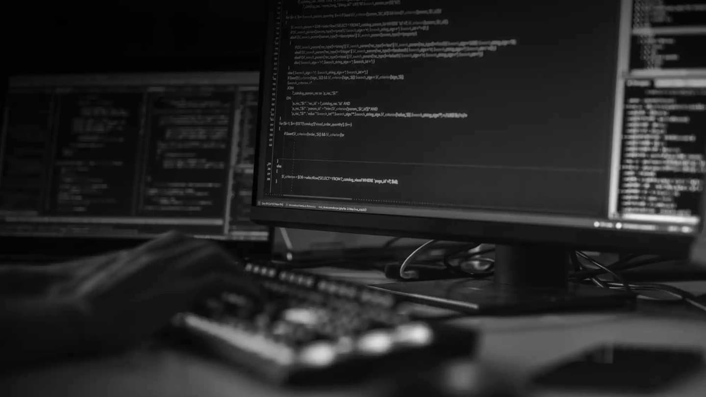 Close-up Focus on Person's Hands Typing on the Desktop Computer Illuminated Keyboard. Screens Show Coding Language User Interface. Software Engineer Create Innovative Commerce App. Program Development